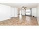 Spacious living room featuring tile flooring and transitions seamlessly into the kitchen and dining areas at 4829 Penoyer Ln, Indianapolis, IN 46235