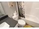 Cozy bathroom featuring a tub with a shower, white vanity sink, toilet, and a dark countertop at 488 Ehrlich Ln, Westfield, IN 46069
