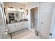 The bathroom has a double sink with white cabinets and a large mirror. It features tiled floors and modern lighting at 488 Ehrlich Ln, Westfield, IN 46069