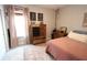 Charming bedroom featuring a bed with pink bedding, a wooden dresser, and a window with striped curtains at 488 Ehrlich Ln, Westfield, IN 46069