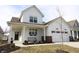 Charming two-story home with a covered porch, bench seating, and a two-car garage at 488 Ehrlich Ln, Westfield, IN 46069