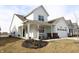 Charming two-story home with a covered front porch and a well-manicured lawn with bare, dormant landscaping at 488 Ehrlich Ln, Westfield, IN 46069