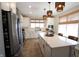 Bright kitchen with stainless steel appliances, a large island, and stylish pendant lights at 488 Ehrlich Ln, Westfield, IN 46069