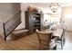 Open concept dining room with wood floors, elegant lighting, and a storage bench at 488 Ehrlich Ln, Westfield, IN 46069