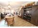 Open-concept living and dining area with wood floors, elegant lighting, and a sliding barn door at 488 Ehrlich Ln, Westfield, IN 46069