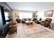 Spacious living room with large tv, brown leather couches and chairs, decorative carpet, and lots of natural light at 488 Ehrlich Ln, Westfield, IN 46069
