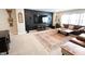This living room has a large TV, a brown leather couch, a decorative rug, and many windows for natural light at 488 Ehrlich Ln, Westfield, IN 46069