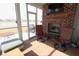 Sun room with screened windows, lake view, brick fireplace and comfortable seating at 488 Ehrlich Ln, Westfield, IN 46069