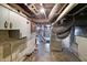 A basement has exposed duct work and utility systems at 505 W Washington St, Shelbyville, IN 46176