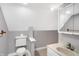 A quaint bathroom features a toilet, sink, and vanity with a mirrored cabinet at 505 W Washington St, Shelbyville, IN 46176