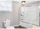 Bathroom with toilet, shower/tub combo, and tiled floors at 505 W Washington St, Shelbyville, IN 46176