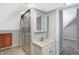 A bright bathroom featuring a shower and sink with tiled floor at 505 W Washington St, Shelbyville, IN 46176