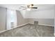 Bedroom featuring gray carpet, gray and white walls, and ceiling fan at 505 W Washington St, Shelbyville, IN 46176