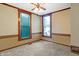 Bedroom featuring neutral carpet, traditional wood trim, and natural light from two windows at 505 W Washington St, Shelbyville, IN 46176