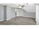 Spacious bedroom featuring a ceiling fan, closet, and neutral gray walls and carpet at 505 W Washington St, Shelbyville, IN 46176