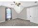 Bedroom featuring a modern ceiling fan, neutral gray walls, carpet, and a window at 505 W Washington St, Shelbyville, IN 46176