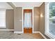 Charming entryway showcasing a wooden door, neutral wall color, and tile flooring at 505 W Washington St, Shelbyville, IN 46176