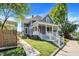 Beautiful two-story home showcasing gray siding, well-maintained landscaping, and a covered front porch at 505 W Washington St, Shelbyville, IN 46176