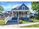 Charming two-story home featuring a welcoming front porch, beautiful landscaping, and gray exterior paint at 505 W Washington St, Shelbyville, IN 46176