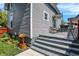 Charming porch with gray painted steps and a small bench beside the gray-sided house at 505 W Washington St, Shelbyville, IN 46176