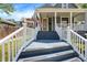 Inviting front porch featuring a seating area, classic design, and well-manicured surroundings at 505 W Washington St, Shelbyville, IN 46176