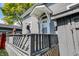 Inviting front porch features stylish railings and decorative accents, enhancing curb appeal of the home at 505 W Washington St, Shelbyville, IN 46176