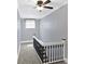 Hallway with dark-trimmed banister, gray walls, white trim and carpeted floors at 505 W Washington St, Shelbyville, IN 46176