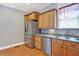 Kitchen view featuring stainless steel refrigerator, cabinets, dishwasher, sink and wood flooring at 505 W Washington St, Shelbyville, IN 46176