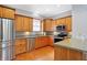Kitchen with stainless steel appliances, wood cabinets, gray walls and wood flooring at 505 W Washington St, Shelbyville, IN 46176