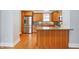 Open concept kitchen with wood cabinets, stainless steel appliances, and wood flooring at 505 W Washington St, Shelbyville, IN 46176