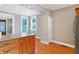 Open kitchen view with wood cabinets, grey walls and wood flooring at 505 W Washington St, Shelbyville, IN 46176