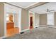 Bright living room with neutral walls, carpet flooring, and seamless flow into the kitchen at 505 W Washington St, Shelbyville, IN 46176