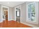Living room with hardwood floors, natural light from windows, and views to other rooms at 505 W Washington St, Shelbyville, IN 46176