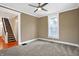 Inviting living room featuring plush carpet, ceiling fan, and a window for natural light at 505 W Washington St, Shelbyville, IN 46176