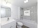 Stylish bathroom with tub and white marble surround, white vanity, updated fixtures, and wood-look floor at 516 W Washington St, Lebanon, IN 46052