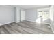 Cozy bedroom with gray walls, white trim, a window for natural light, and wood-look flooring at 516 W Washington St, Lebanon, IN 46052
