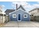 Exterior view of a detached garage with a blue door and concrete driveway at 516 W Washington St, Lebanon, IN 46052