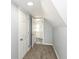 Hallway featuring carpet, doors, and view into the bathroom at 516 W Washington St, Lebanon, IN 46052
