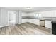 Spacious kitchen with stainless steel appliances, white cabinets, granite countertops, and wood-look flooring at 516 W Washington St, Lebanon, IN 46052