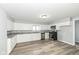 Charming kitchen with white cabinets, granite countertops, stainless steel appliances, and wood-look flooring at 516 W Washington St, Lebanon, IN 46052