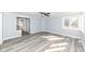 Bright living room with gray walls, white trim, modern ceiling fan, and beautiful wood-look floors at 516 W Washington St, Lebanon, IN 46052