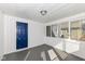 Bright sunroom with white brick walls and blue door, offering ample natural light at 516 W Washington St, Lebanon, IN 46052