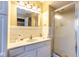 Bathroom with a shower and white vanity with light tiling and a large mirror at 5629 Crittenden Ave, Indianapolis, IN 46220