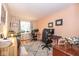 Bedroom with warm paint features two workspaces near a window and a sitting area at 5629 Crittenden Ave, Indianapolis, IN 46220