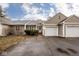 Charming townhouse featuring attached garages and well-maintained landscaping at 5629 Crittenden Ave, Indianapolis, IN 46220
