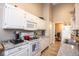 Bright kitchen with white cabinets, granite countertops, and modern appliances at 5629 Crittenden Ave, Indianapolis, IN 46220