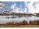 Lake view featuring lush foliage, reeds, and calm water at 5629 Crittenden Ave, Indianapolis, IN 46220