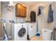 Functional laundry room with washer, dryer, cabinet storage, and wire shelving at 5629 Crittenden Ave, Indianapolis, IN 46220