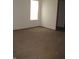 Neutral carpet and a bright window create an inviting atmosphere in this cozy bedroom at 5820 N Nebo Rd, Muncie, IN 47304