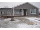 Charming single-story home with a covered porch, gray siding, and a well-maintained front yard at 5820 N Nebo Rd, Muncie, IN 47304